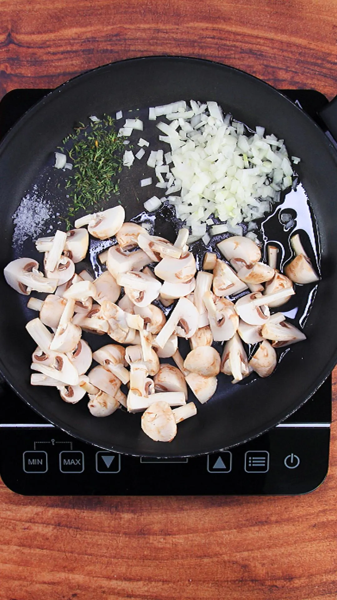 Sautéing onions and mushrooms with thyme and salt.