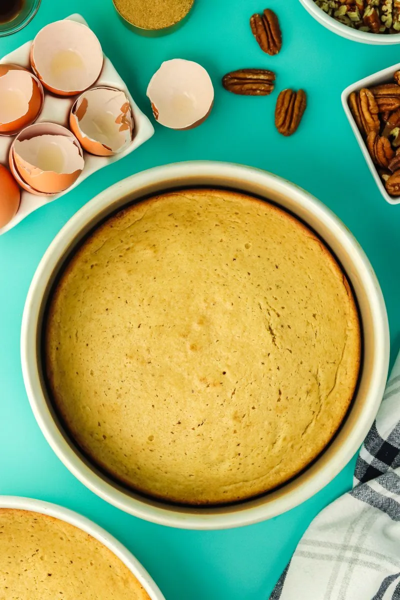 Round cake pans holding baked golden brown cakes- Hostess At Heart