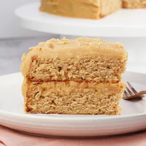 Table view of a two layered spice cake frosted with peanut butter frosting.