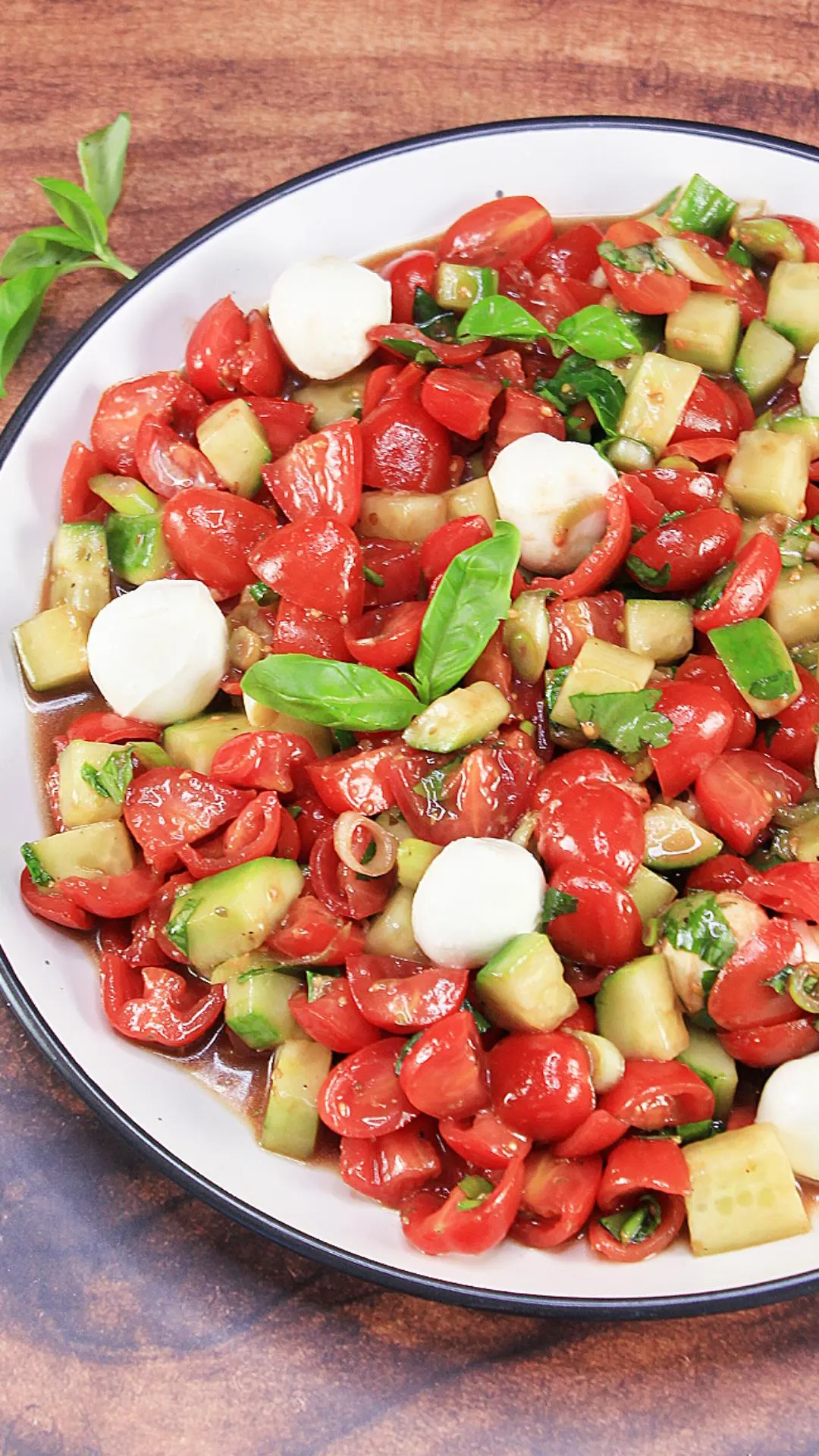 Finished tomato and mozzarella salad in a serving platter.