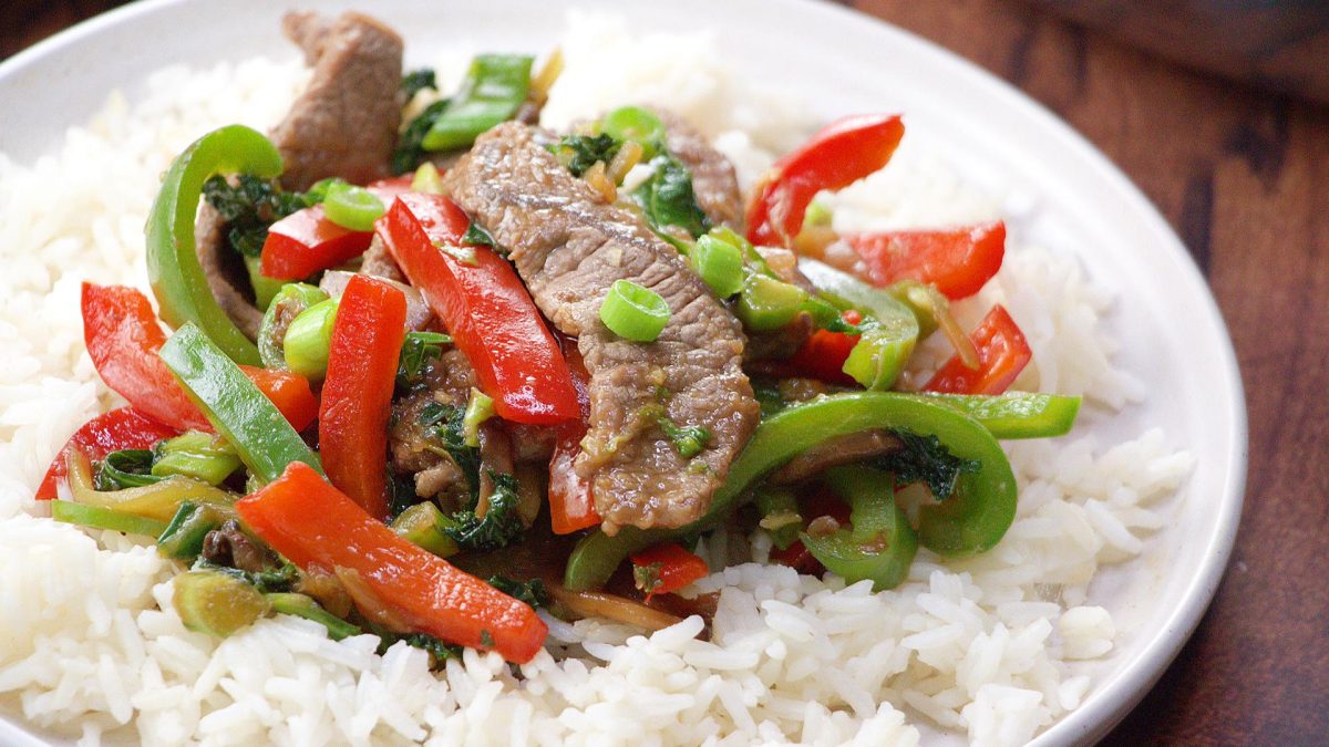 White Plate with Mongolian Beef Stir Fry over rice. 