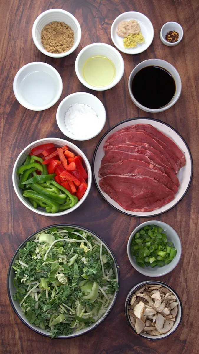 Ingredients for Mongolian Beef Stir Fry: Brown sugar, grated ginger and garlic, red pepper flakes, oil, corn starch, water, soy sauce, green onions, broccoli slaw, mushrooms, red pepper, and green pepper.