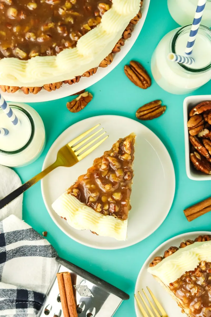 Top down view of slices of pecan cake topped with praline and edged and the sides frosted with buttercream - Hostess At Heart