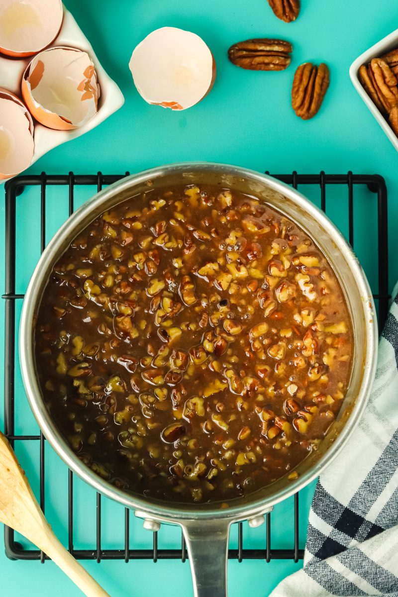 Pecan pie filling ingredients cooked in a saucepan - Hostess At Heart