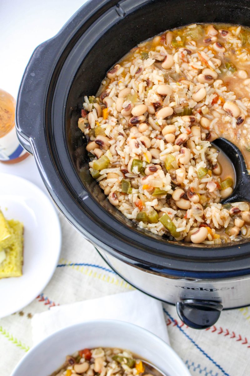 A slow cooker filled with hoppin john uncooked ingredients. Hostess At Heart