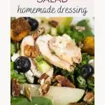 Top down view of a salad of greens topped with sauteed pears, blueberries, slices of chicken, goat cheese crumbles and croutons - Hostess At Heart