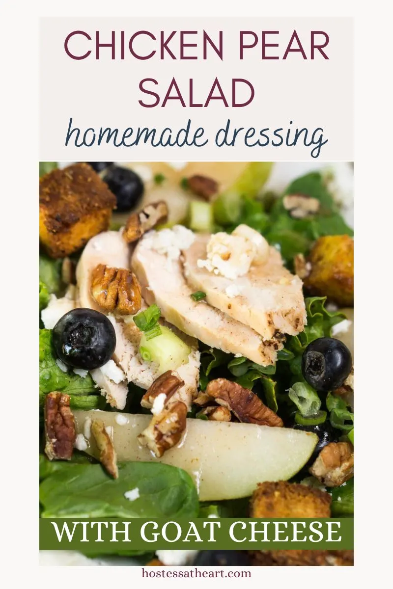 Top down view of a salad of greens topped with sauteed pears, blueberries, slices of chicken, goat cheese crumbles and croutons - Hostess At Heart