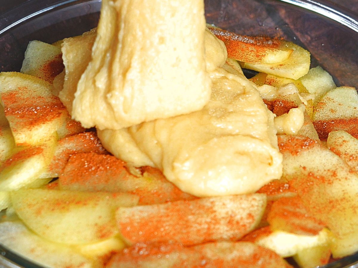 Topping crust mixture poured over an apple filling in a pie plate - Hostess At Heart