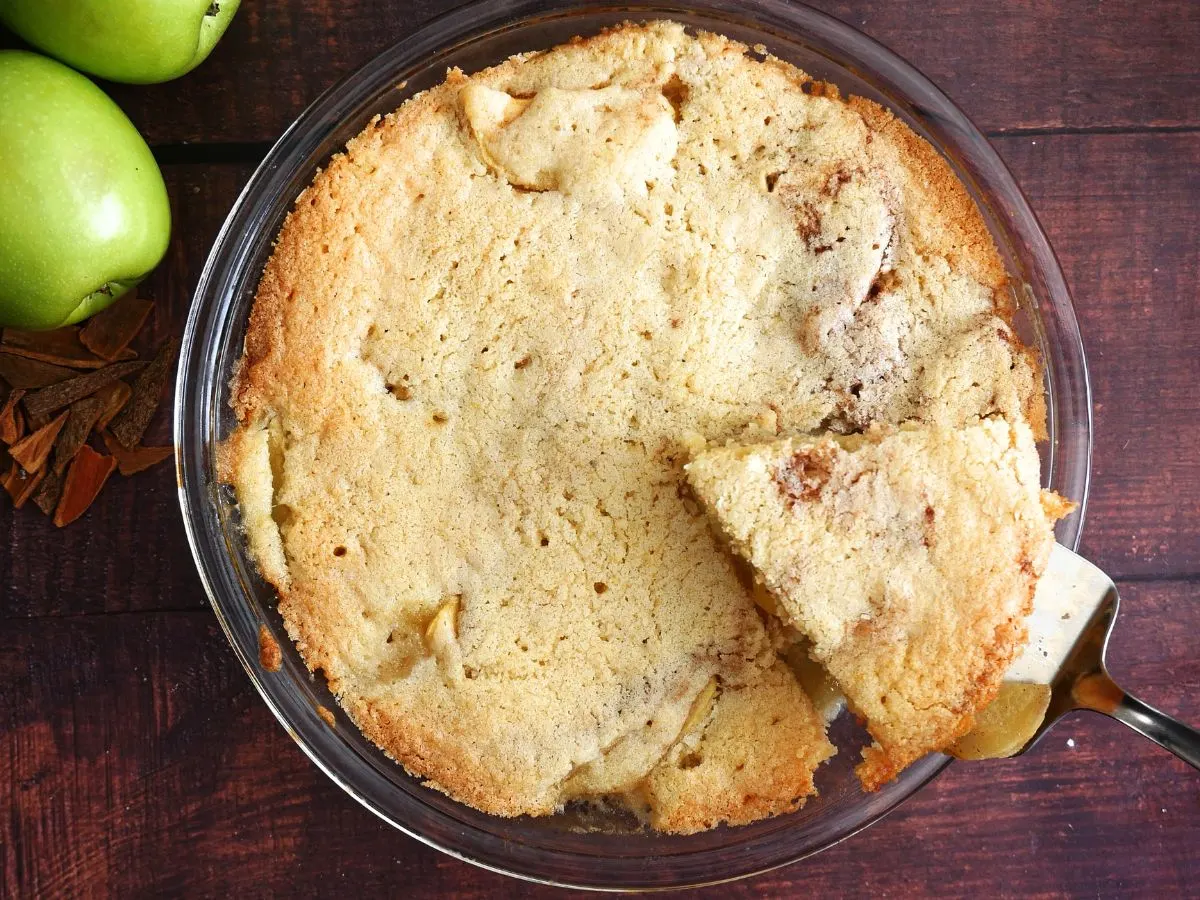 Top down view of a baked pie with a sliced wedge being lifted out - Hostess At Heart