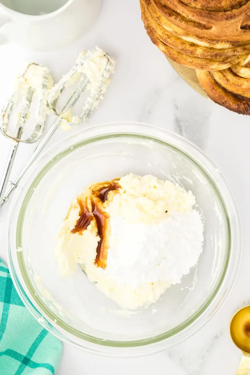 Mixing bowl filled with butter, powdered sugar, and vanilla. Hostess At Heart