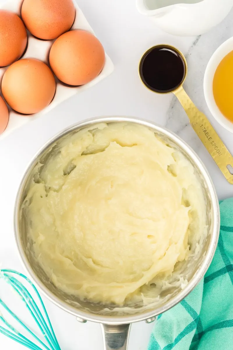 Top down view of a saucepan filled with flour and milk cooked to a thick paste.