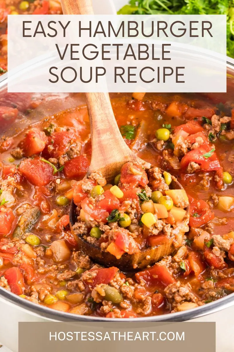 Angled view of a bowl of Hamburger and vegetable soup with a wooden spoon lifting a serving. Hostess At Heart