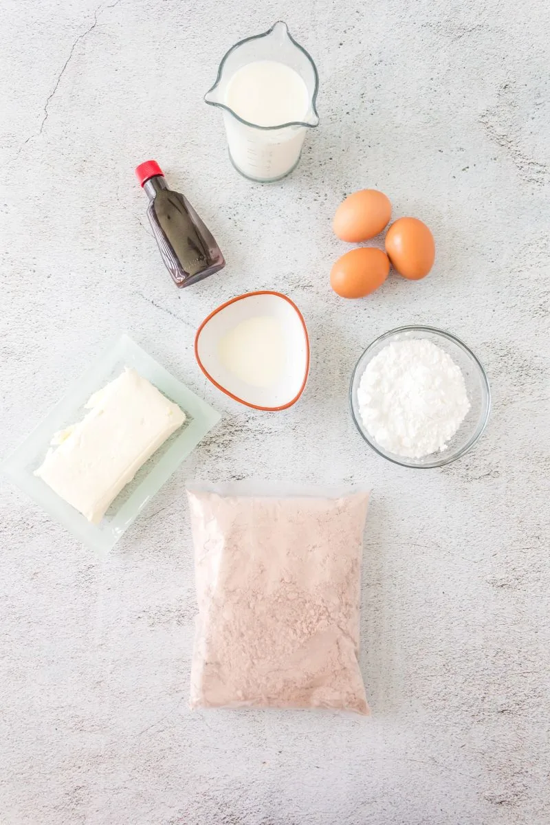 Ingredients for Red Velvet Donut Recipe using cake mix, eggs, milk, vanilla, powdered sugar, and cream cheese.