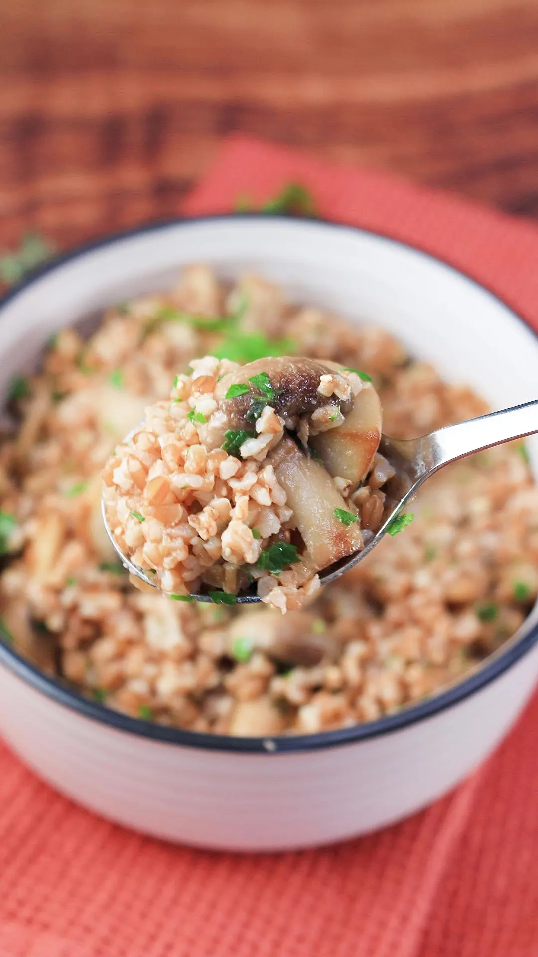 Close-up view of a spoon filled with cooked faro with mushrooms - Hostess At Heart