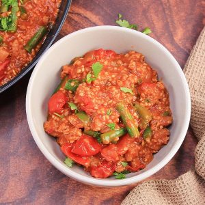 Top down view of a bowl filled with a ground sausage, bulgur, and green bean skillet recipe - Hostess At Heart