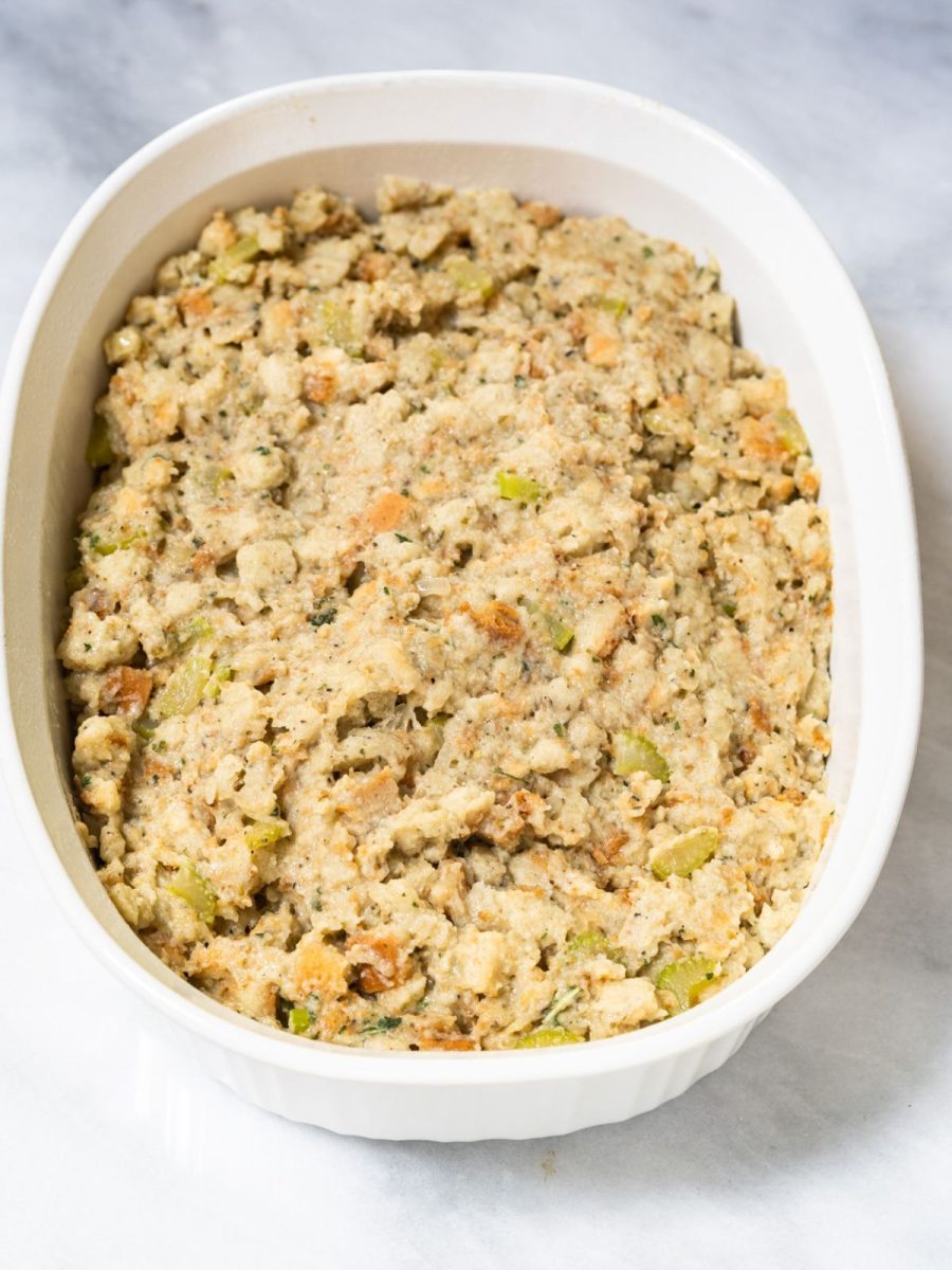 A casserole dish filled with combined ingredients for homemade dressing. Hostess At Heart