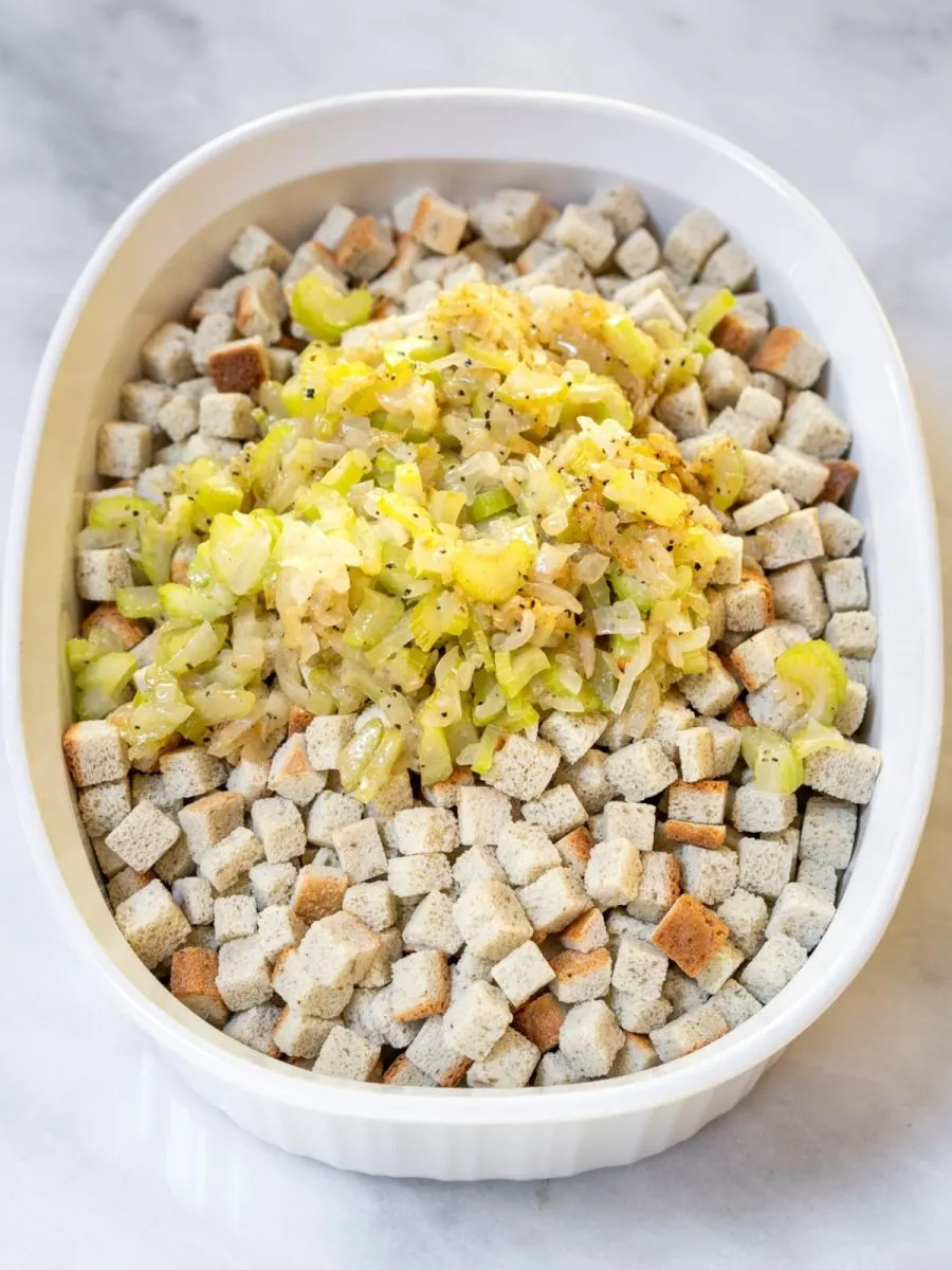 A casserole dish topped with butter sauteed onion and celery. Hostess At Heart