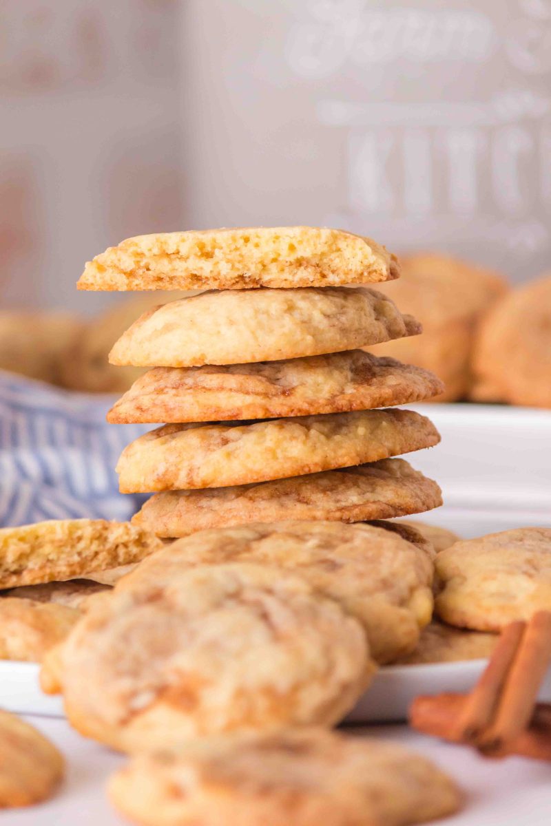 Stack of cinnamon cookies with some facing outward at the base of the stack.