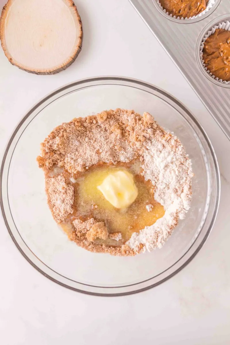 Melted butter added to a mixing bowl filled with crumble ingredients. Hostess At Heart