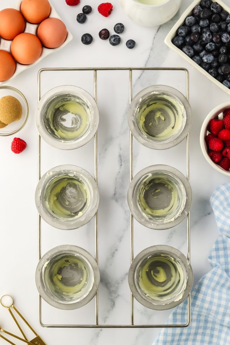 Top down view of a popover pan with buttered cups - Hostess At Heart