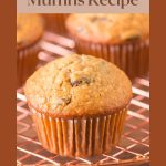 An image for Pinterest of a oatmeal raisin muffin sitting on a cooling rack - Hostess At Heart