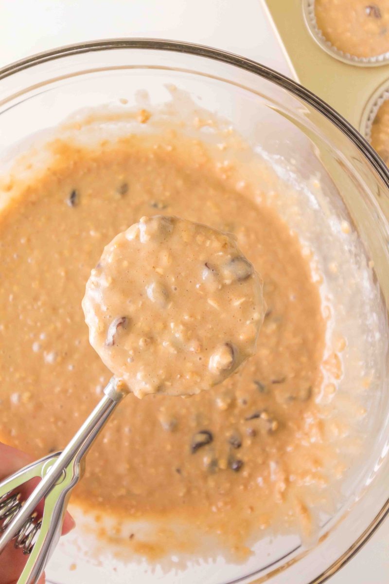 A scoop filled with batter hovering over a mixing bowl - Hostess At Heart