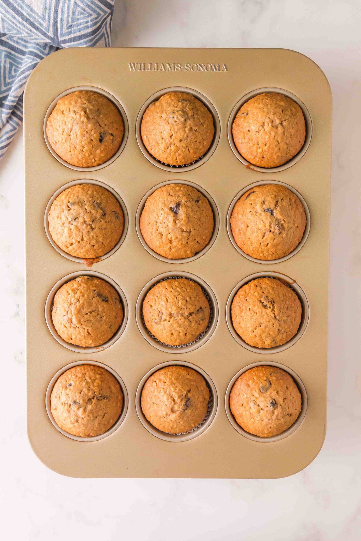 Raisin Muffins in a muffin pan on the counter.