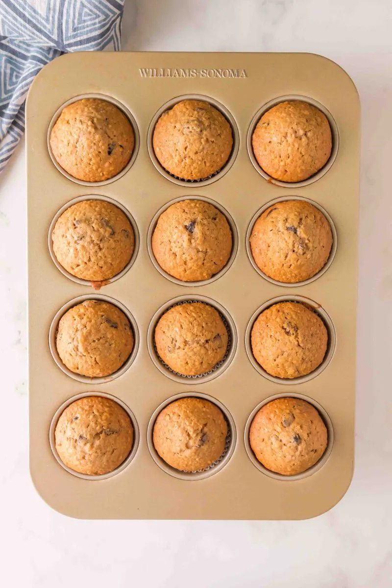 Raisin Muffins in a muffin pan on the counter. 