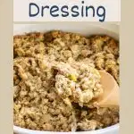 Sideview of a casserole dish of Thanksgiving dressing with a serving spoon lifting a portion. Hostess At Heart