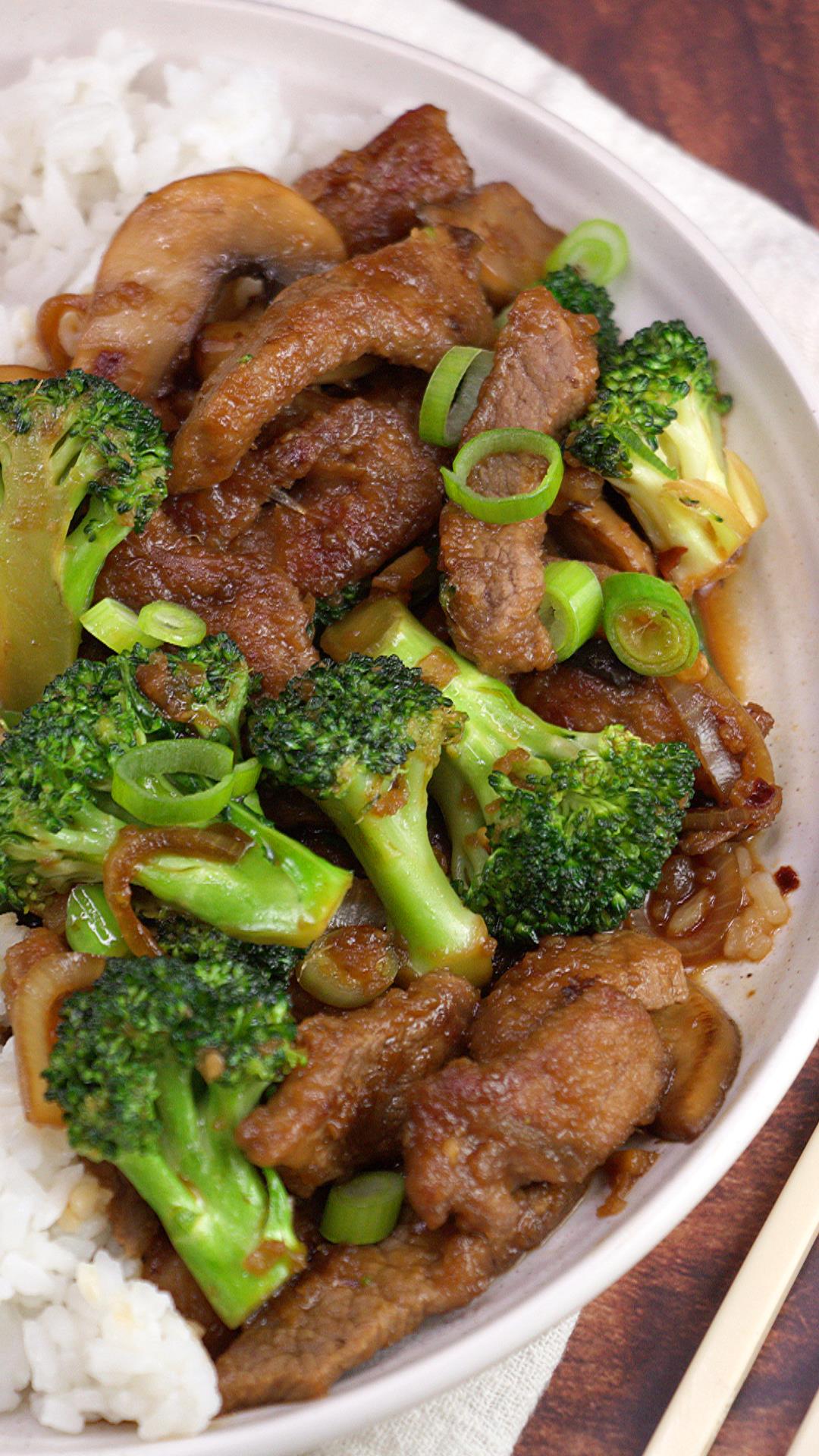 White plate with beef and broccoli stir fry over white rice.