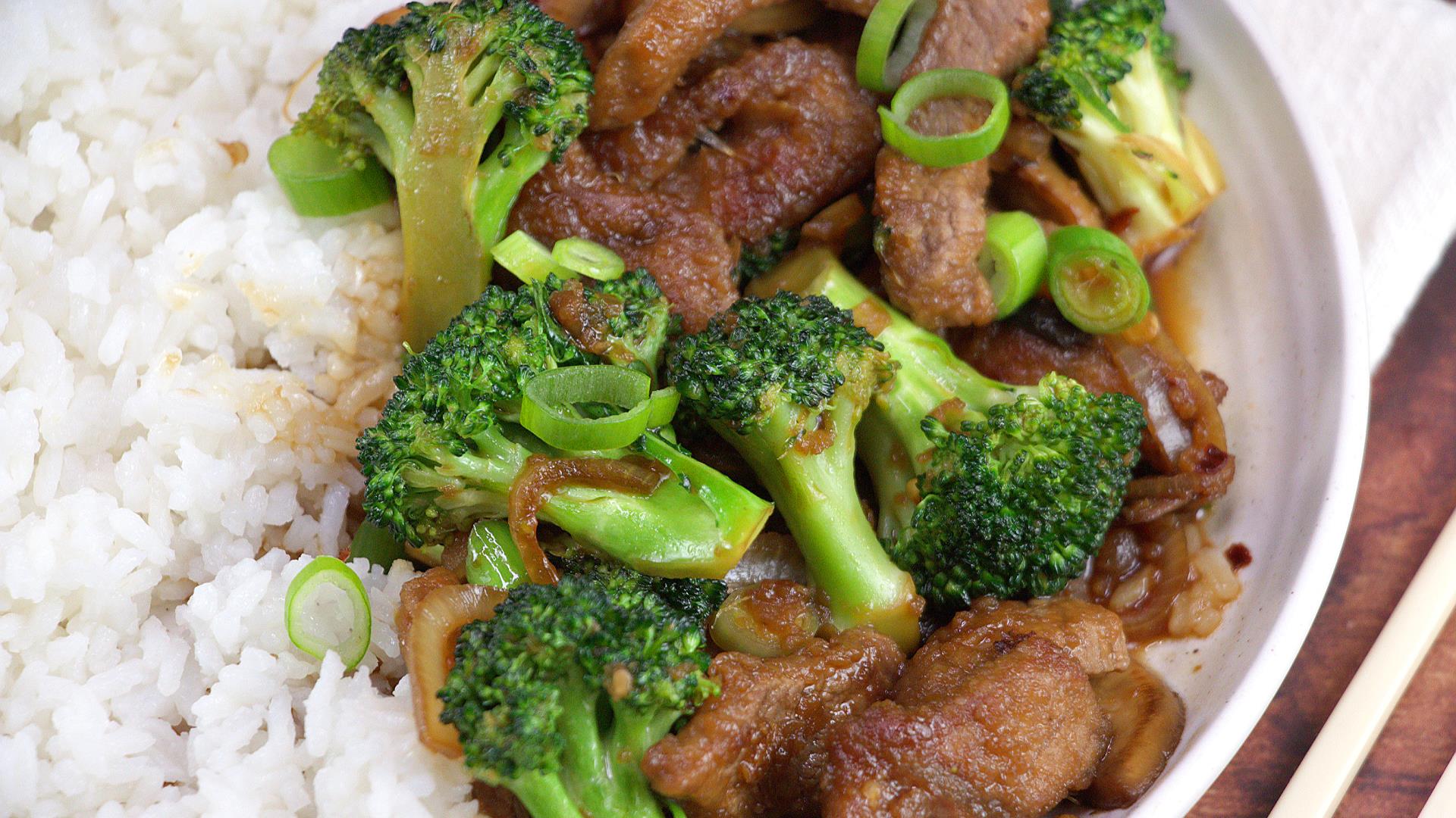 Beef and Broccoli Stir Fry on a white plate over rice.