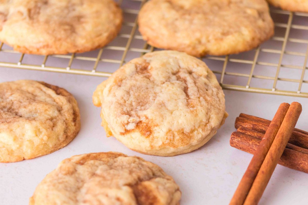 Baked sugar cookies with a cinnamon swirl sitting on a cooling rack. Hostess At Heart