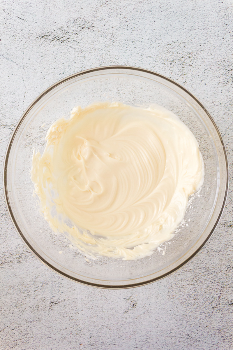 A bowl filled with vanilla glaze mixed smoothly