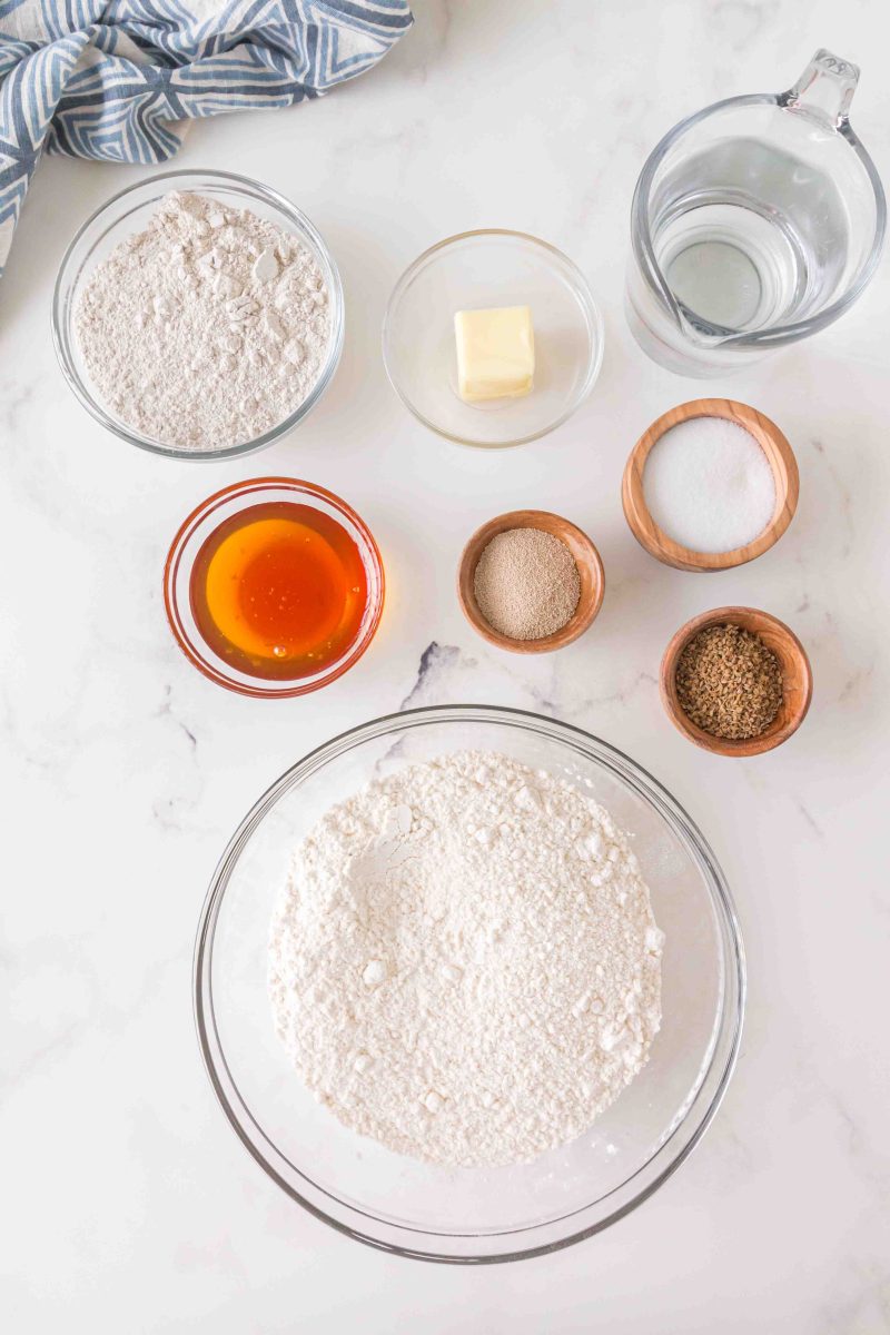 Ingredients for the Rye Bread Recipe. Flour, butter, water, honey, yeast, sugar, salt, whole wheat flour, caraway seeds.