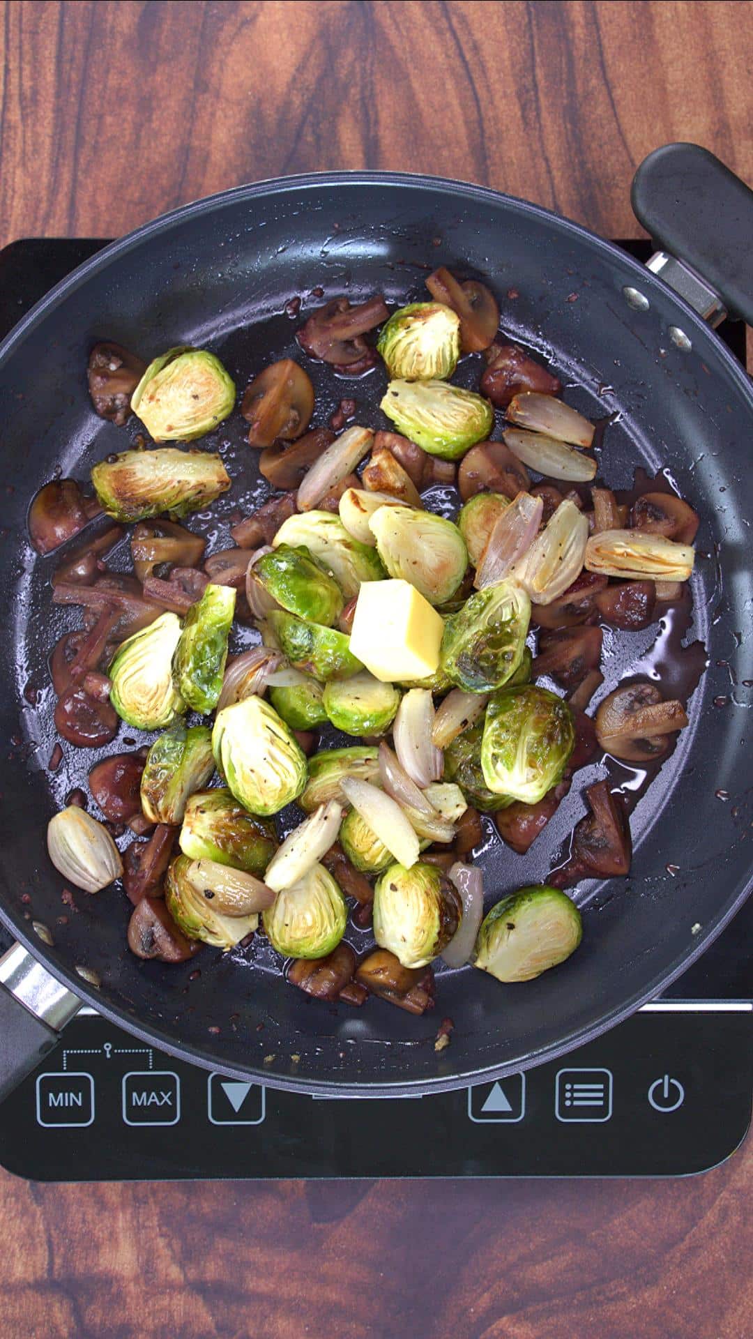 Butter and the Roasted Veggies in a skillet.