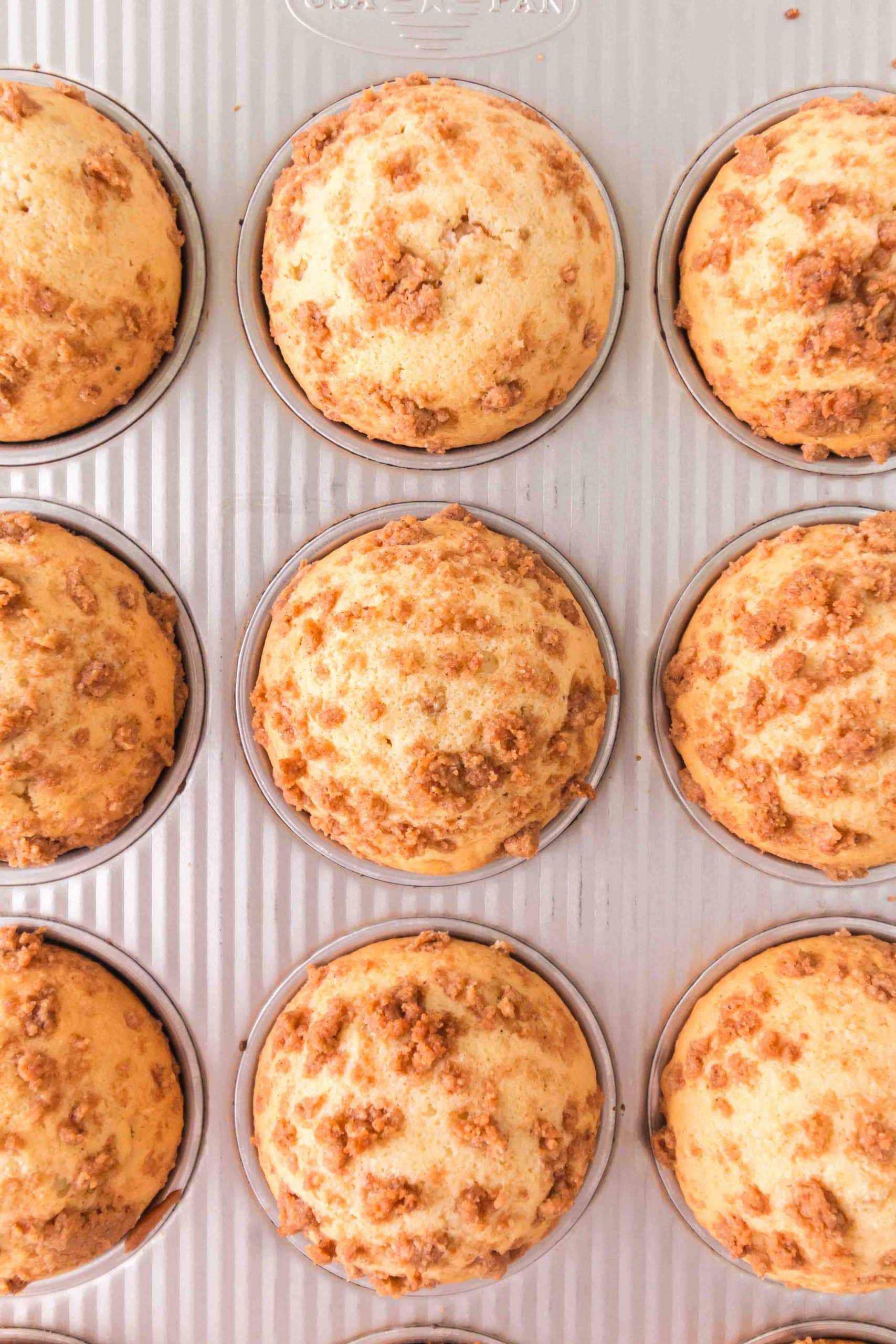 Top down view of a pan of baked cinnamon roll muffins - Hostess At Heart