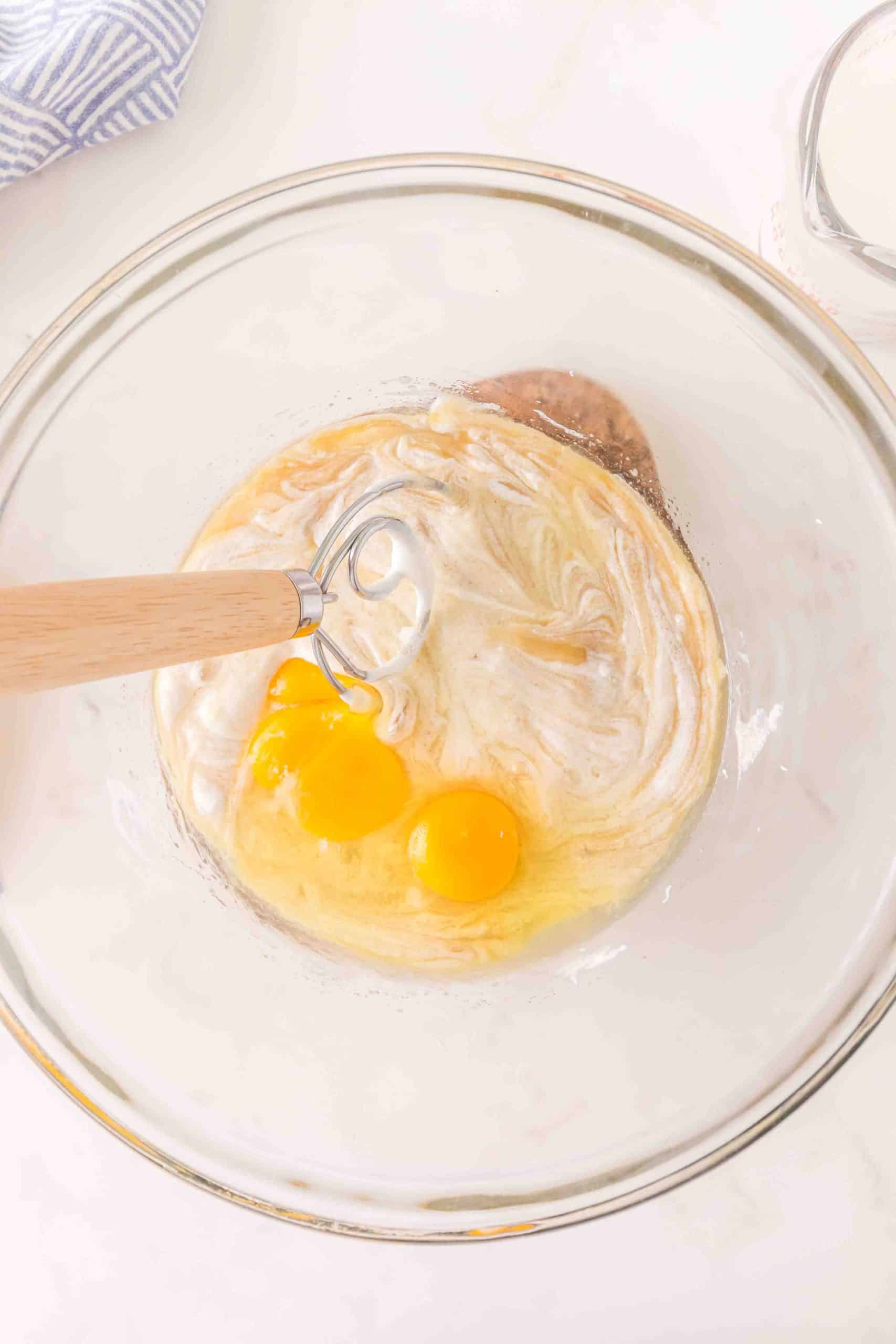 Sourcream and eggs added to wet muffin batter in a bowl. Hostess At Heart