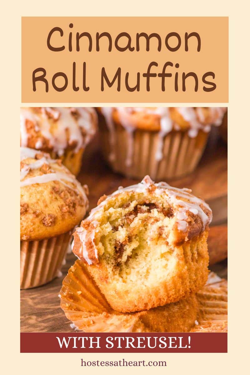 An image for Pinterest of a cinnamon roll muffin with a bite taken out of it showing a ribbon of cinnamon and sugar. The top has crumble and is glazed - Hostess At Heart