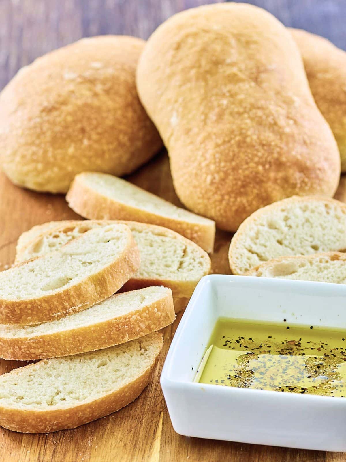Front view of slices of ciabata bread next to a bowl of dipping sauce - Hostess At Heart