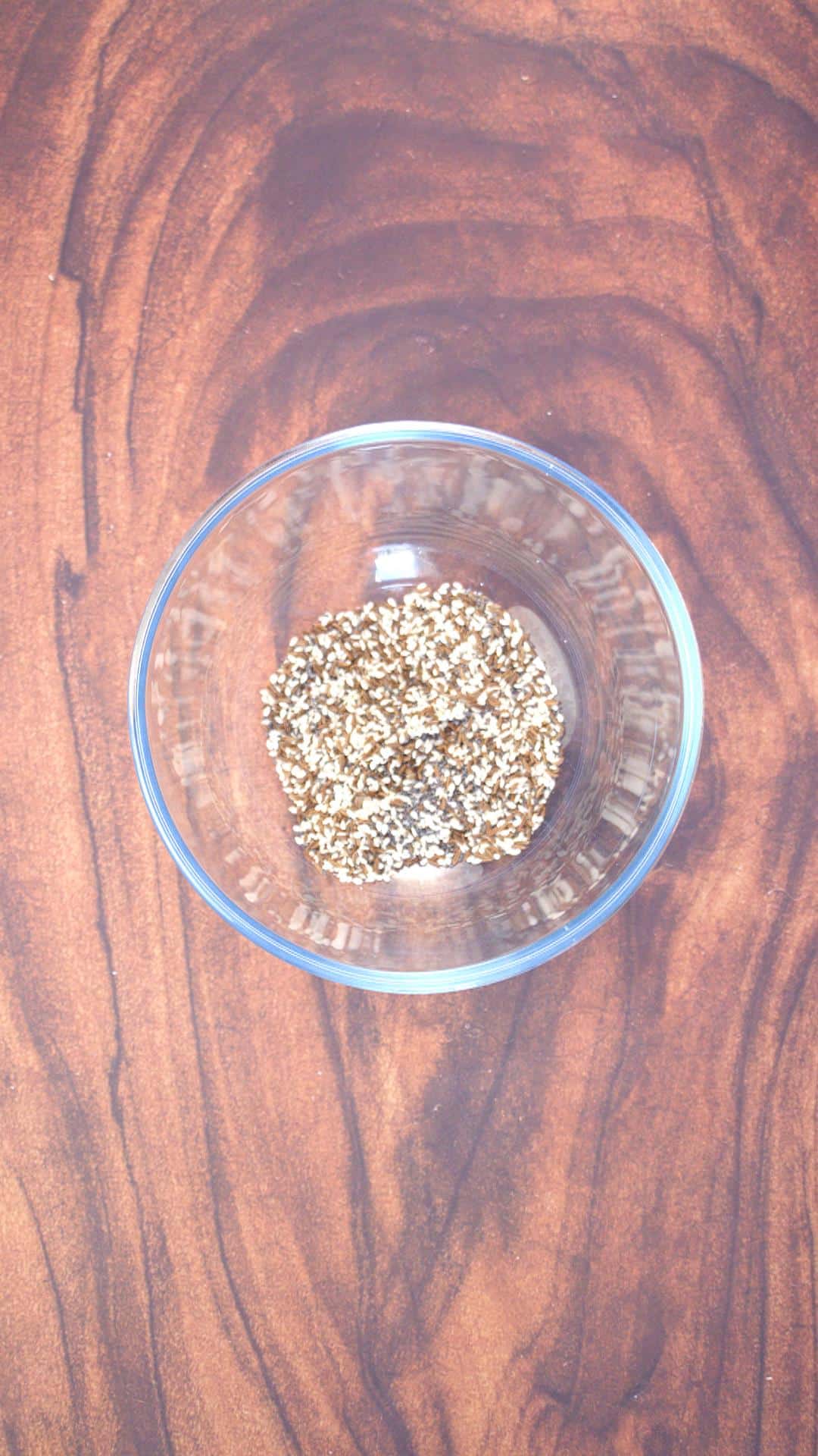Thre types of seeds mixed together in a small mixing bowl.
