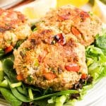 Angled view of a golden brown crispy tuna patty sitting on a bed of lettuce - Hostess At Heart