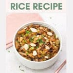 An image for Pinterest of Top down view of a white bowl filled with cooked wild rice, celery, onion, mushrooms, chestnuts, and spices. It's Garnished with sliced almonds and parsley. Hostess At Heart