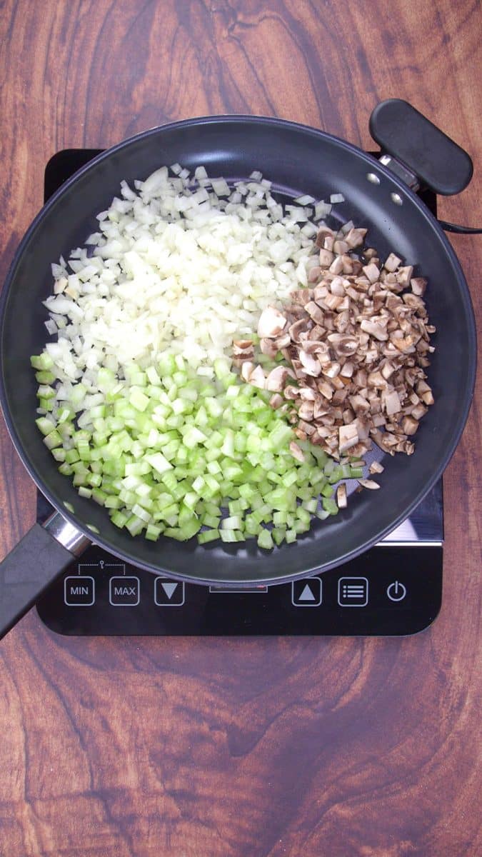 A skillet filled with chopped celery, onions, and mushrooms. Hostess At Heart