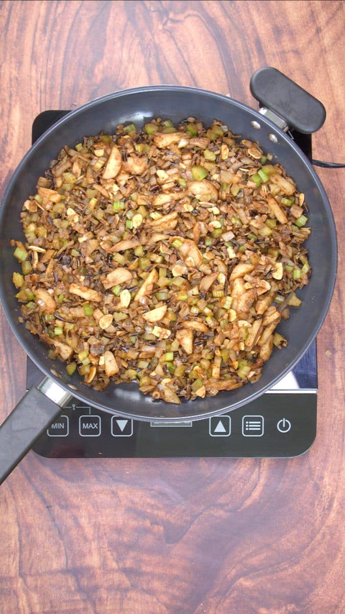 Top down view of a skillet filled with cooked 5 spice rice. Hostess At Heart