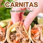 An image for Pinterest of a hand holding a pork carnitas taco stuffed with tomatoes and avocado - Hostess At Heart