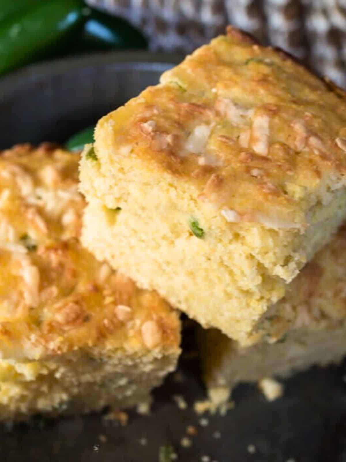 A stack of three slices of jalapeno cheddar cornbread. - Hostess At Heart