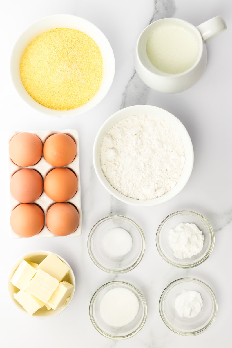 Ingredients measured out in bowl including butter, buttermilk, eggs, cornmeal, flour, baking powder, baking soda, salt, and sugar. Hostess At Heart