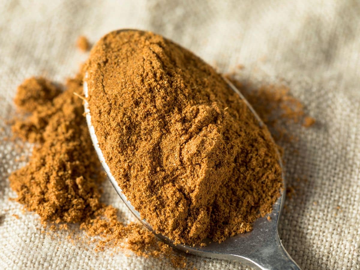 Top down view of a spoon filled with 5 spice powder. Hostess At Heart
