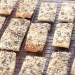 Angled view of homemade seeded crackers on a cooling rack - Hostess At Heart