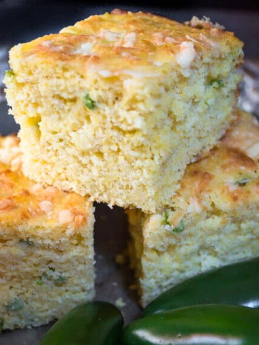 Top down view of spicy cornbread squares stacked on each other - Hostess At Heart